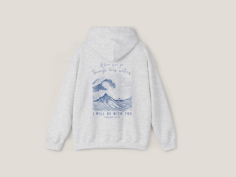 Back of Sand hoodie. Front says, Isaiah 43 2. Back of hoodie is Isaiah 43 2 scripture with illustration of waves in blue
