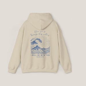 Back of Sand hoodie. Front says, Isaiah 43 2. Back of hoodie is Isaiah 43 2 scripture with illustration of waves in blue