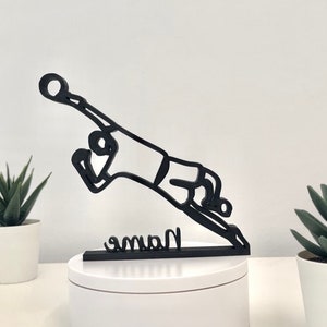 May include: Black silhouette of a soccer player diving to save a ball, with the word "Name" written on a base.
