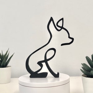 Peut inclure: Silhouette noire d'un chihuahua assis sur une base ronde blanche. La silhouette est en bois et est un simple dessin au trait.