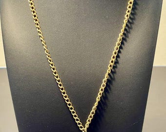May include: A gold chain necklace with a large, purple, irregularly shaped stone pendant.