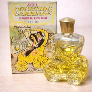 May include: Vintage Avon "Courting Carriage" cologne bottle and box. The clear glass bottle is shaped like a yellow carriage with a gold-coloured cap. The box features a yellow carriage illustration with the text "Flower Talk Cologne 1 fl. oz."
