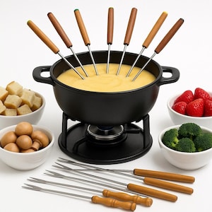 May include: A black fondue pot with wooden-handled forks, surrounded by bowls of bread cubes, mushrooms, strawberries, and broccoli. The fondue pot sits on a burner, ready for a delicious meal.