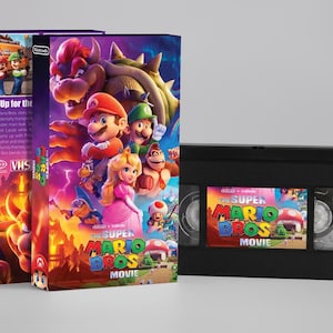 May include: The Super Mario Bros. Movie VHS tape and box set. The box art features Mario, Luigi, Princess Peach, and Bowser. The VHS tape has a colorful label with the movie title.