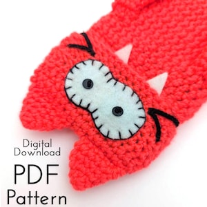 May include: A bright red crocheted monster hat with light blue felt eyes, black bead pupils, and white felt teeth. The text "Digital Download PDF Pattern" is printed on the image.
