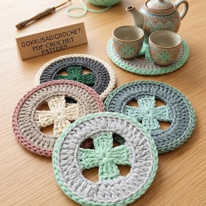 May include: Crocheted coasters in various colors, including gray, pink, and green, arranged on a wooden surface. The coasters feature a cross design in the center and are surrounded by a circular border. A wooden sign reads "GOKKUSAGICROCHET: PDF CROCHET PATTERN".