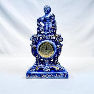 Old vintage made in Germany branded Mercedes porcelain mechanic clock in blue gold colors with cupids