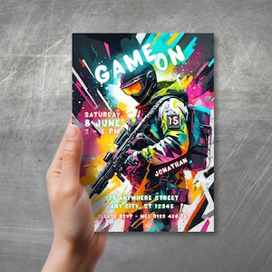 Puede incluir: Una invitaci&oacute;n colorida para una fiesta de videojuegos con un jugador en camuflaje sosteniendo un arma. La invitaci&oacute;n dice "GAMEON" e incluye la fecha, la hora y la ubicaci&oacute;n de la fiesta.