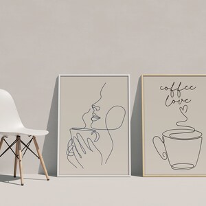 May include: Two framed prints with line art drawings. The first print features a woman's face with a cup of coffee. The second print features a cup of coffee with steam and the text "coffee love".