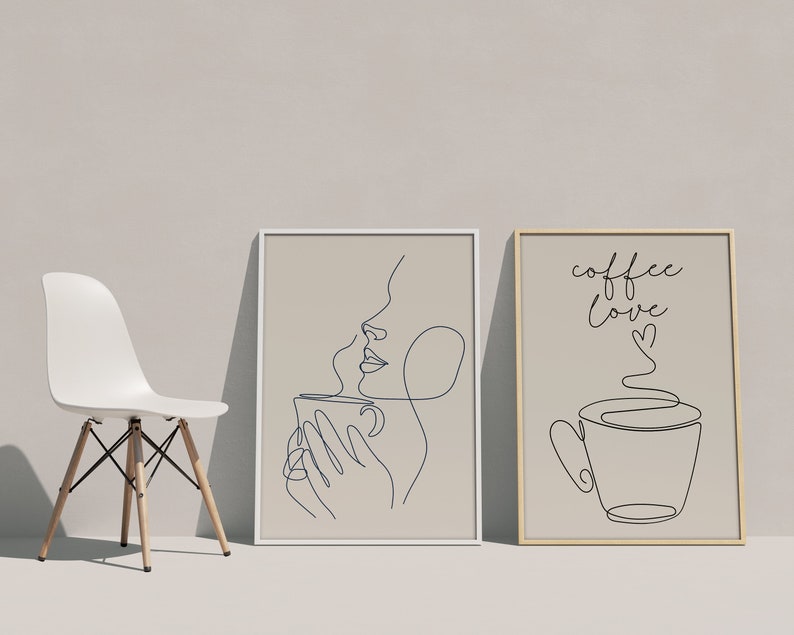 May include: Two framed prints with line art drawings. The first print features a woman's face with a cup of coffee. The second print features a cup of coffee with steam and the text "coffee love".