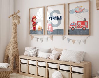 May include: Three framed watercolor prints with a fire fighter, the name "STEPHAN", and a fire truck and helicopter. The prints are in a child's room with a giraffe toy, storage bench, and pillows.
