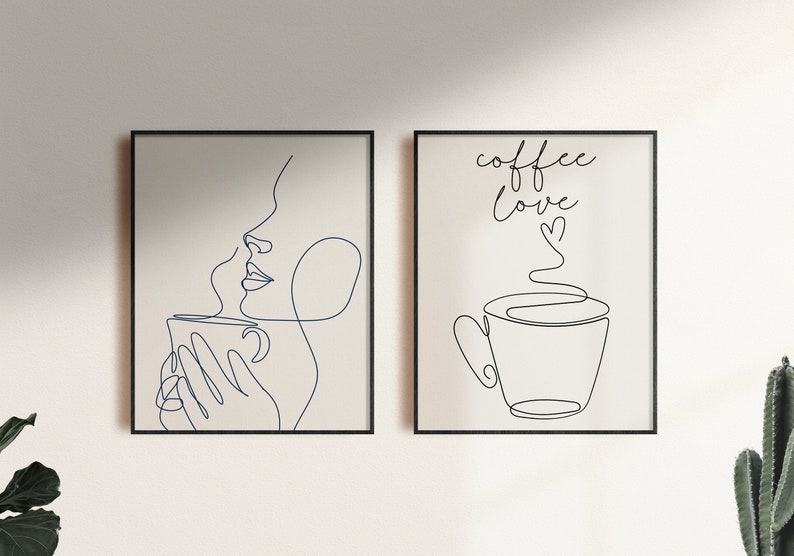 May include: Two framed black and white line art prints. The left print features a woman drinking from a cup with steam rising from the cup. The right print features a cup of coffee with steam rising from the cup and the text "coffee love" with a heart.