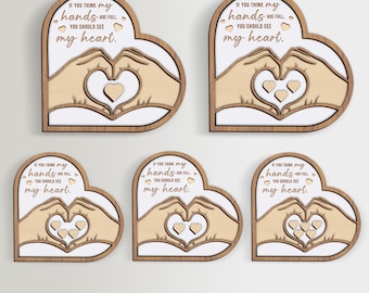 May include: Five wooden heart-shaped signs with the text "If you think my hands are full, you should see my heart." The signs feature a pair of hands forming a heart shape with smaller hearts inside.