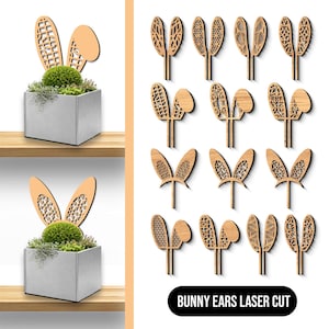 Puede incluir: Decoraciones de orejas de conejo de madera cortadas con láser con varios patrones. La imagen también muestra una maceta cuadrada con una planta verde y detalles de orejas de conejo. El texto "BUNNY EARS LASER CUT" está presente.