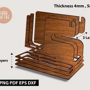 May include: A wooden organiser with three layers, designed to be laser cut. The organiser has a rectangular base and a curved top. The text "Thickness 4mm, 5mm" and "3 Layers" is visible on the image. The text "LASER CUT FILE" and "SVG PNG PDF EPS DXF" is also visible on the image.