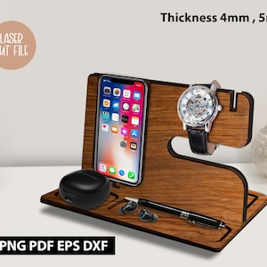 May include: Wooden phone stand with a watch holder, a phone slot, and a small compartment for earbuds. The stand is made of light brown wood and has a black outline. The text "Thickness 4mm, 5mm" is visible in the image.