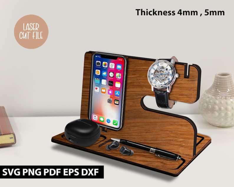 May include: Wooden phone stand with a watch holder, a phone slot, and a small compartment for earbuds. The stand is made of light brown wood and has a black outline. The text "Thickness 4mm, 5mm" is visible in the image.