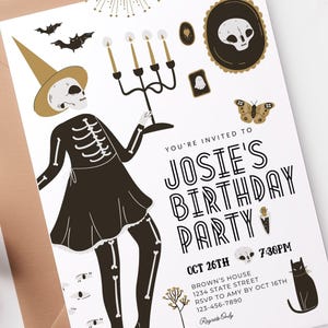 May include: A white invitation card with black text for a birthday party. The text reads "You're invited to Josie's Birthday Party". The card is decorated with a skeleton wearing a black dress and a witch's hat, a candelabra, a butterfly, a cat, and other Halloween-themed illustrations.