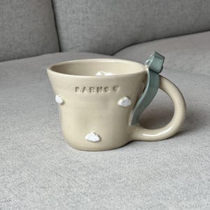 grey blue bow with clouds ceramic mug
