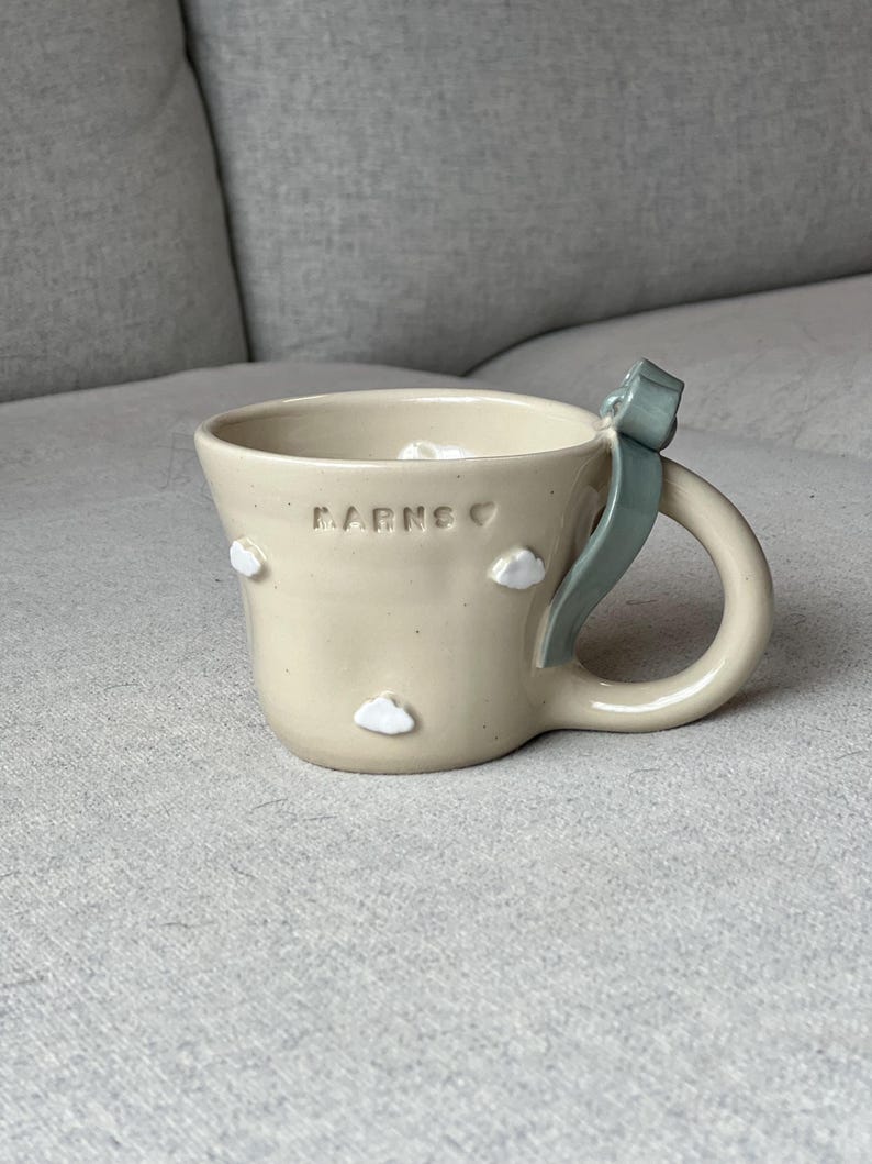 grey blue bow with clouds ceramic mug