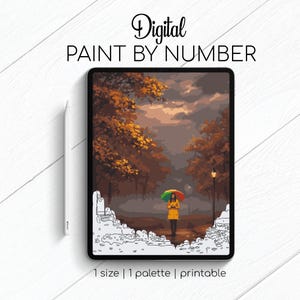 May include: Digital paint by number image on a tablet. The artwork depicts a person in a yellow coat holding a colorful umbrella, walking on a path lined with trees. The text "Digital Paint By Number" is at the top.