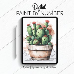 May include: Digital paint by number image of a cactus plant in a terracotta pot with red flowers. The image is on a tablet screen with a stylus next to it.