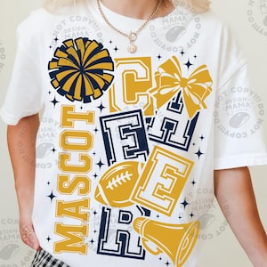 May include: A white short-sleeve t-shirt featuring a graphic design with the word CHEER in large block letters, the word MASCOT, a navy blue pom-pom, a gold hair bow, a gold football, and a gold megaphone, all accented by small dark blue stars.