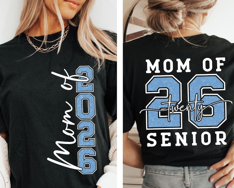 May include: Black t-shirt with the text "Mom of 2026" in white script and the number "2026" in light blue. The back of the shirt reads "Mom of 26 Twenty Senior" in white and light blue.