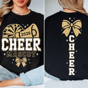 May include: A black crewneck sweatshirt featuring a gold glitter graphic on the front with a megaphone, the text 2026 CHEER MASCOT, and a bow. The back displays a large gold glitter bow above the vertical text CHEER with small star accents.