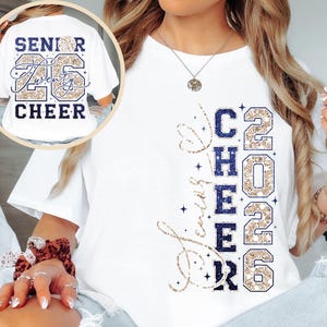 May include: White t-shirt with the words "Senior Twenty 26 Cheer" printed on the back and "Love Cheer 2026" on the front. The design features navy blue and gold glitter accents, perfect for cheerleading.