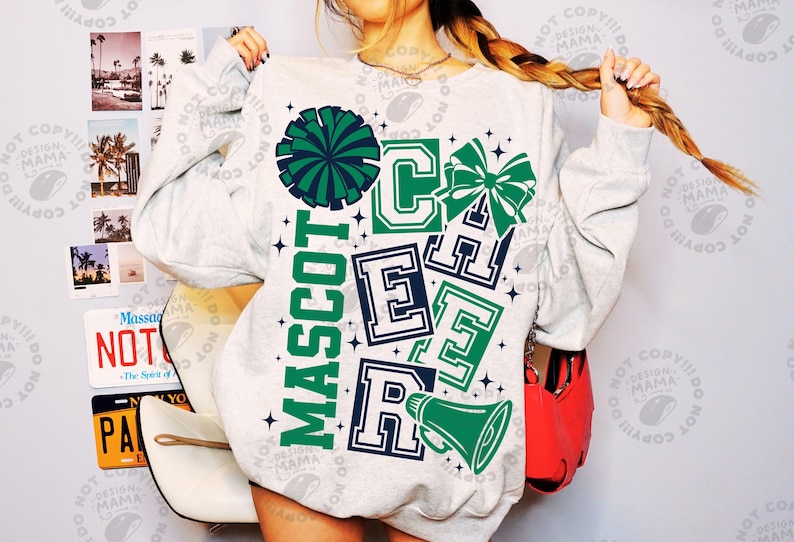 May include: A light gray sweatshirt with a cheerleading design. The design includes the word "MASCOT" in green, and the word "CHEER" in green and navy blue. A green pom-pom, bow, and megaphone are also featured.