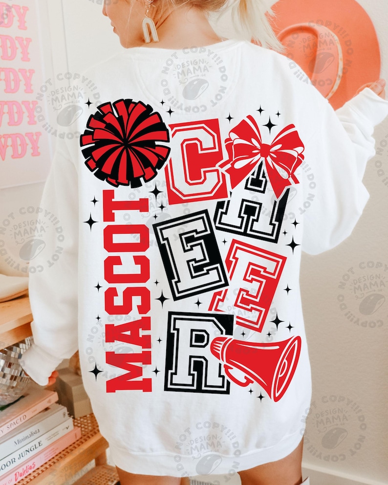 May include: White sweatshirt with a red and black cheerleader design. The design includes a pom-pom, bow, megaphone, and the word "MASCOT CHEER" in a collegiate font. Black star accents complete the design.