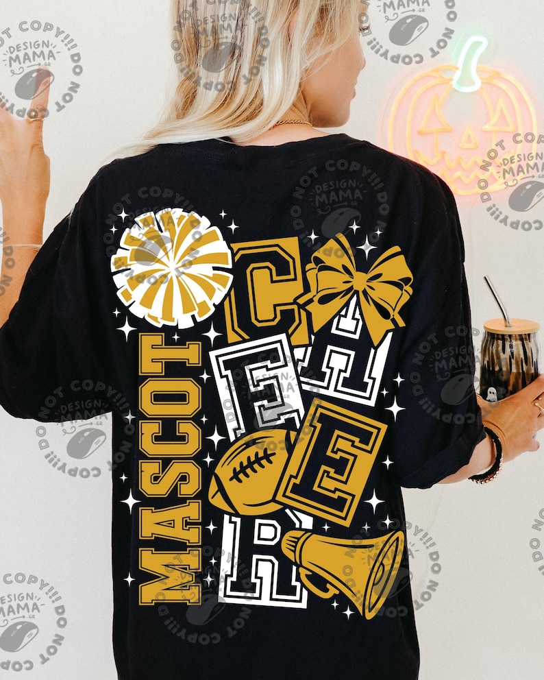 May include: A black t-shirt featuring a graphic design with the word MASCOT CHEER in gold and white block lettering. The design includes a gold pom-pom, a gold hair bow, a brown football, and a gold megaphone, all surrounded by small white stars.