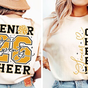May include: Cream-colored t-shirts with black and gold text. One shirt reads "SENIOR 26 CHEER" with a cheerleader graphic. The other shirt says "Senior Cheer 2026" vertically. A great gift for cheerleaders.