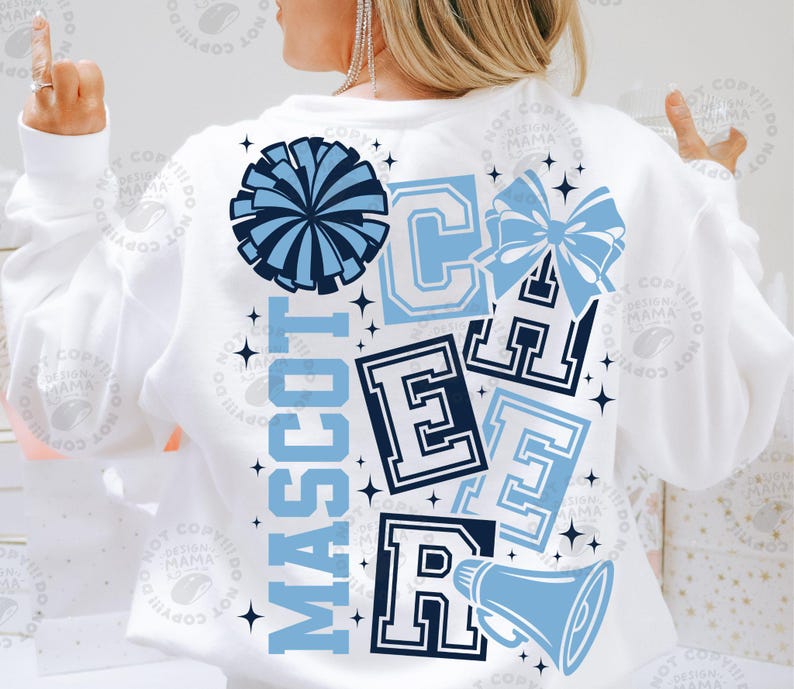 May include: White sweatshirt with a blue and navy design. The design includes the word "MASCOT" vertically, along with the letters "C", "E", "A", and "R", a pom-pom, a bow, a megaphone, and stars.