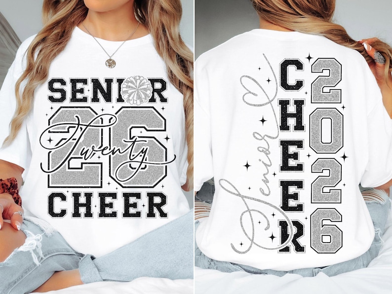 May include: White t-shirt with the words "SENIOR 26 CHEER" in black and silver glitter lettering. The back of the shirt has "SENIOR CHEER 2026" in a similar design. A pom-pom graphic is above the number 26.