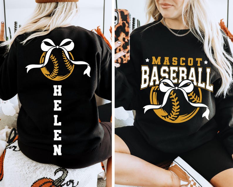 Peut inclure: Sweat-shirt noir avec un motif de baseball et le texte "MASCOT BASEBALL". Le motif comprend une balle de baseball avec un n&oelig;ud et un ruban blancs. Le dos du sweat-shirt porte le nom "HELEN" en blanc.
