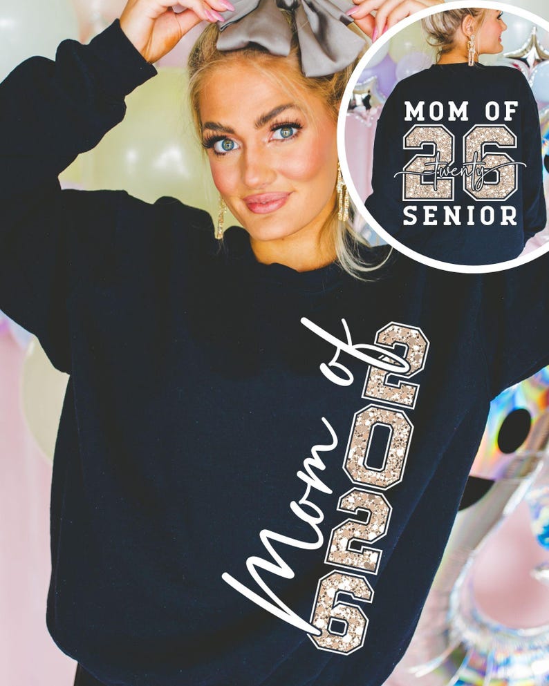 May include: Black sweatshirt with the text "Mom of 26" in a white script and "26" in a gold glitter font. The back of the sweatshirt has the text "Mom of 26 Senior" in white and gold glitter.