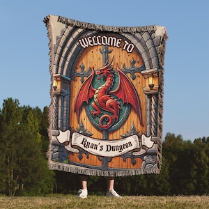 May include: A woven tapestry featuring a medieval-style stone archway with a wooden door. The door is decorated with a red dragon and the text "Welcome to Ryan's Dungeon".
