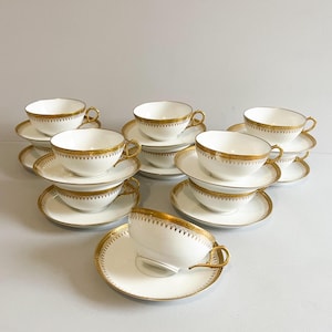 11 white and gold porcelain tea or coffee cups, Bernardaud, Limoges, mid-20th century