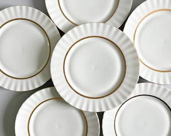 6 old flat plates in white and gold porcelain, mid-20th century