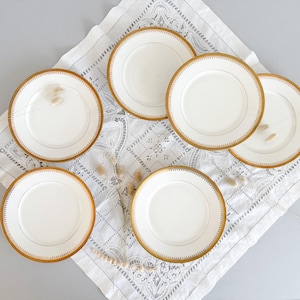 Flat plates in white and gold porcelain, Limoges, mid-20th century