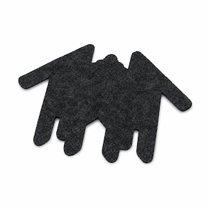 May include: A dark charcoal gray felt coaster shaped like a stylized bat with outstretched wings and pointed ears. The surface has a textured, fibrous appearance characteristic of pressed felt material, featuring a flat, die-cut silhouette design.