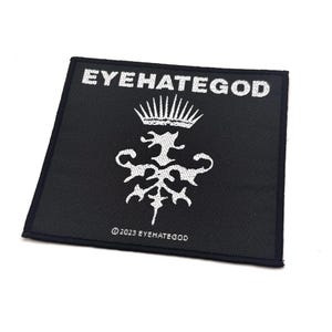 May include: A square black patch featuring white text and a detailed emblem. The words "EYEHATEGOD" are at the top, with an intricate design beneath. The copyright notice "&copy; 2023 EYEHATEGOD" is at the bottom.