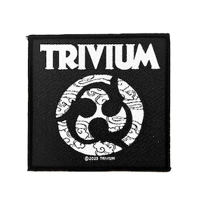 May include: A square black and white embroidered patch featuring the word TRIVIUM in a bold font at the top. Below the text is a circular emblem with a three-part symbol set against a cloud pattern. The text ©2023 TRIVIUM is printed at the bottom.