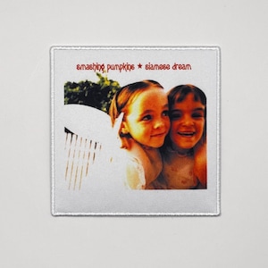May include: Square white patch featuring the album art from Smashing Pumpkins' "Siamese Dream." The image shows two young girls smiling, with the band name and album title in red text above.