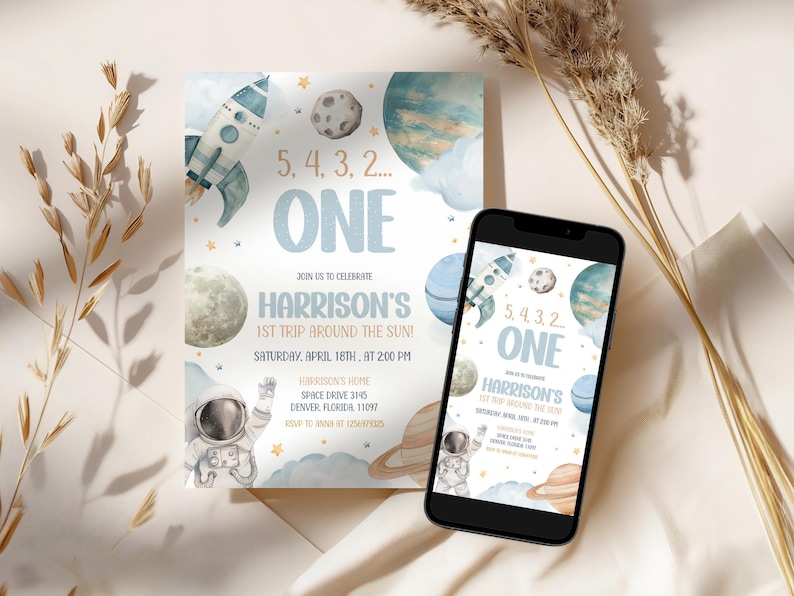 May include: A blue and white invitation with a rocket ship, planets, and stars. The text reads "5, 4, 3, 2... ONE" and "Harrison's 1st Trip Around the Sun!"