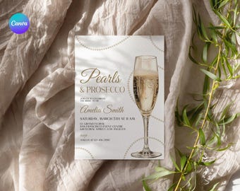 May include: A white invitation card with gold text and a pearl border. The text reads "Pearls & Prosecco" and includes the details for a bridal shower for Amelia Smith. The card features a glass of champagne.