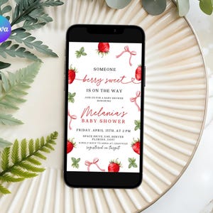 May include: A digital invitation for a baby shower with a strawberry theme. The invitation features a white background with red strawberries, green leaves, and pink ribbons. The text reads "Someone berry sweet is on the way."  The invitation also includes the name of the baby shower honoree, "Melania's Baby Shower", the date and time of the event, and the location.
