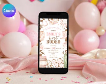 以下が含まれることがあります： スマートフォンには、「Emily's First Rodeo」のロデオをテーマにした招待状が表示されています。招待状には、カウボーイブーツ、帽子、樽が描かれており、日付、時間、場所が記載されています。電話はピンクの風船とキラキラ光るピンクの表面に囲まれています。